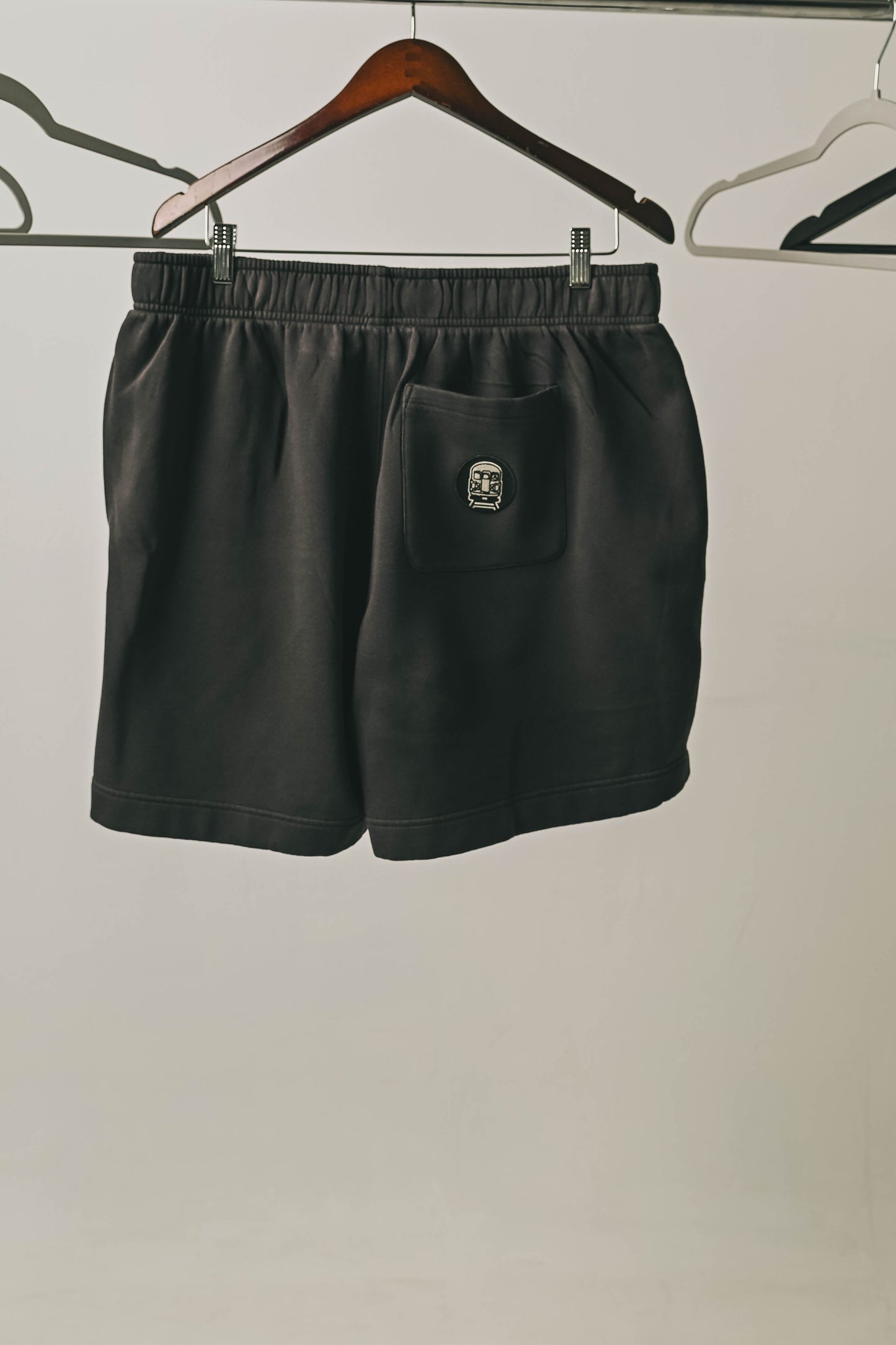 We Show Up Shorts with embroidered emblem on the back pocket.