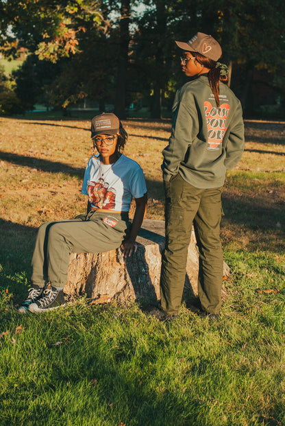 Two models wearing Love You More sweatshirt and sweatpants with the ARG hat.
